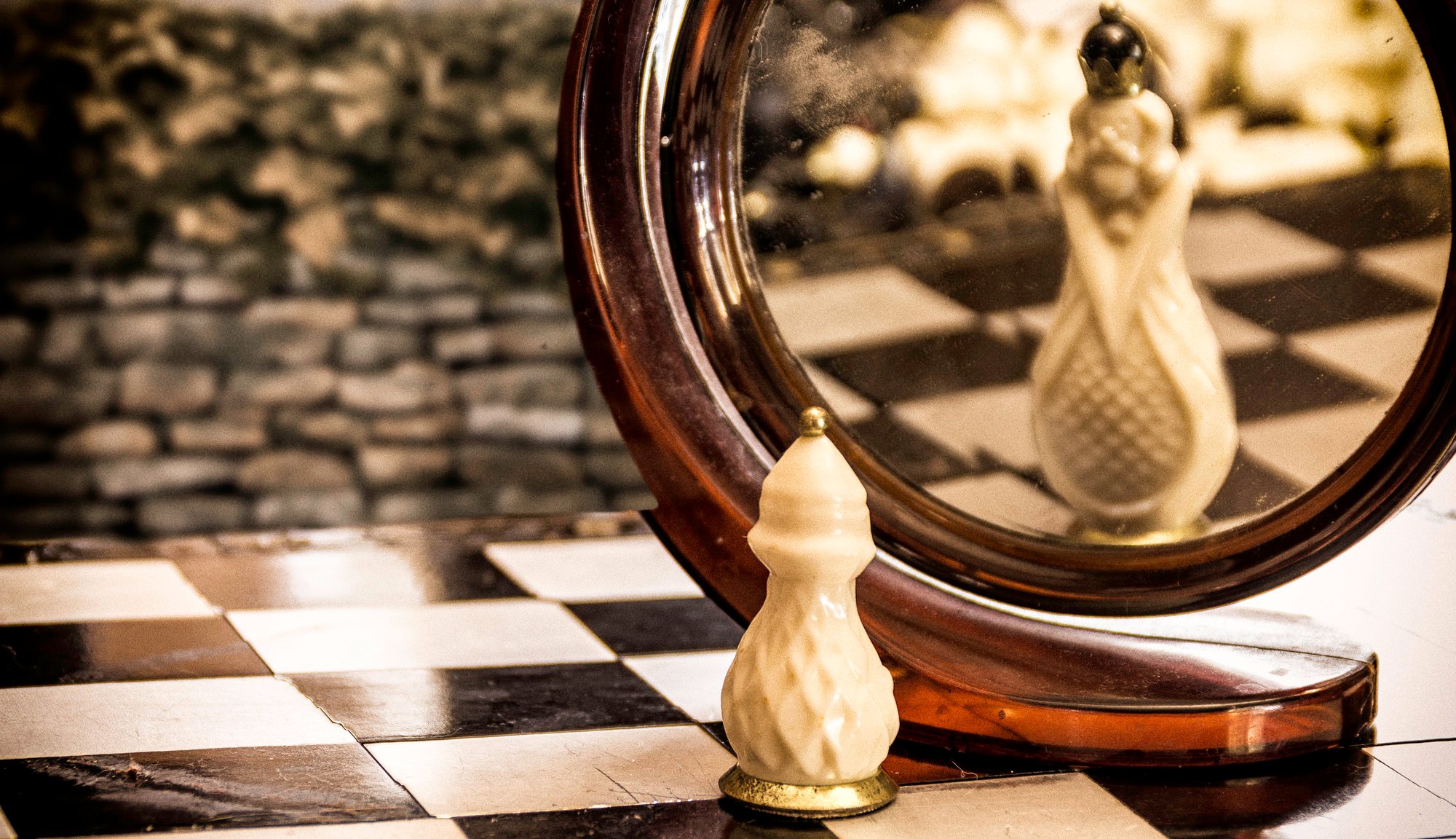 A chess game token looking at the mirror and seeing themselves bigger