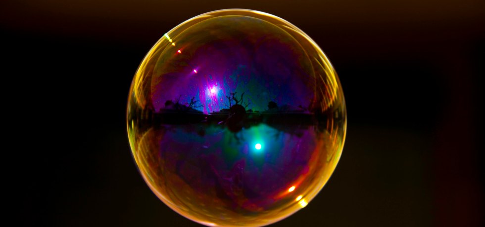 multicoloured bubble floating in black space