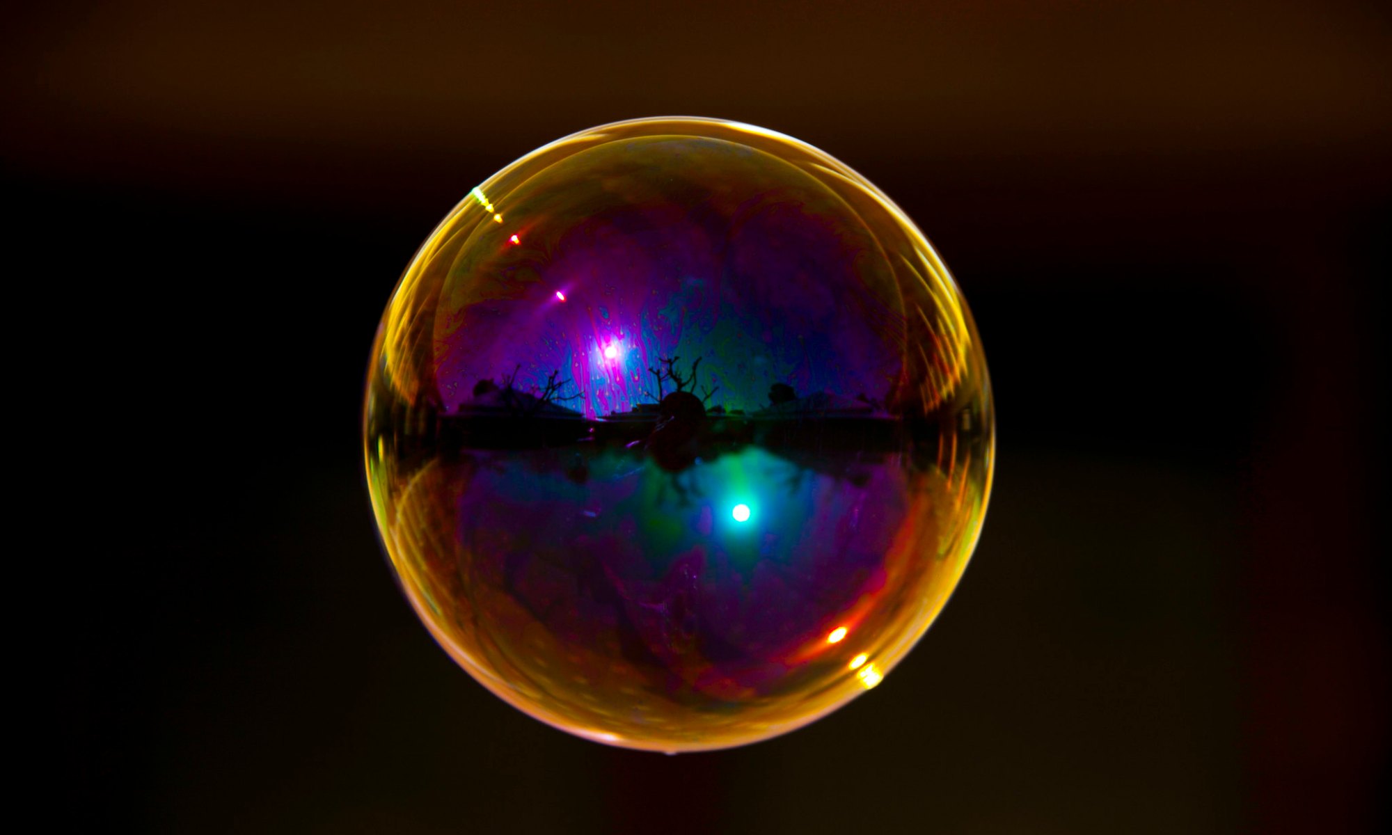 multicoloured bubble floating in black space